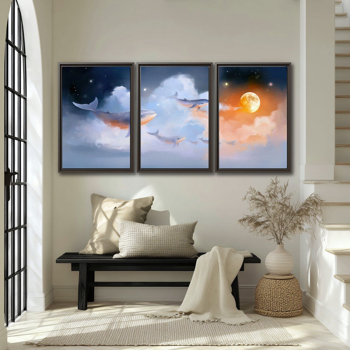 Blue whales gliding through pastel clouds beneath stars and a warm orange moon 3 piece framed canvas wall art displayed in a entryway