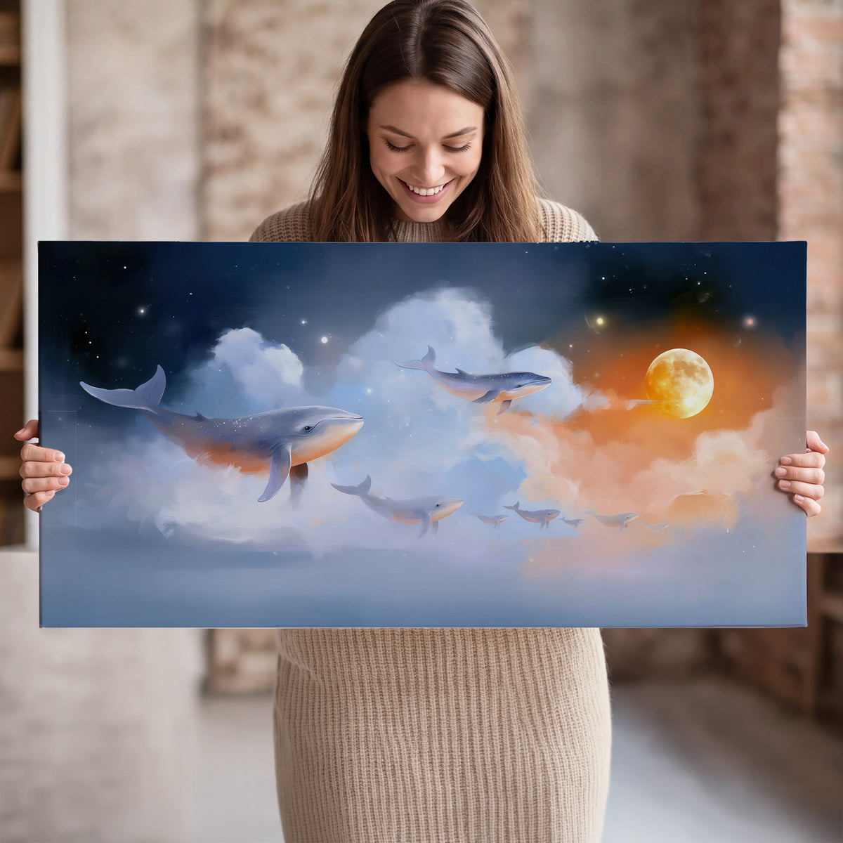 Blue whales gliding through pastel clouds beneath stars and a warm orange moon single canvas wall art held in hands