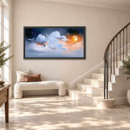 Blue whales gliding through pastel clouds beneath stars and a warm orange moon single framed canvas wall art styled in an interior