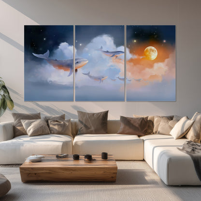 Blue whales gliding through pastel clouds beneath stars and a warm orange moon set of 3 poster prints displayed in a living room