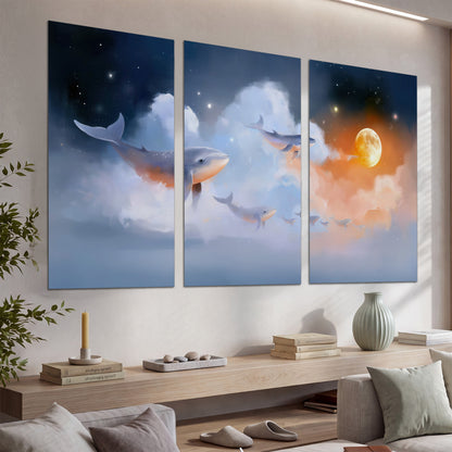 Blue whales gliding through pastel clouds beneath stars and a warm orange moon set of 3 poster prints displayed in a console