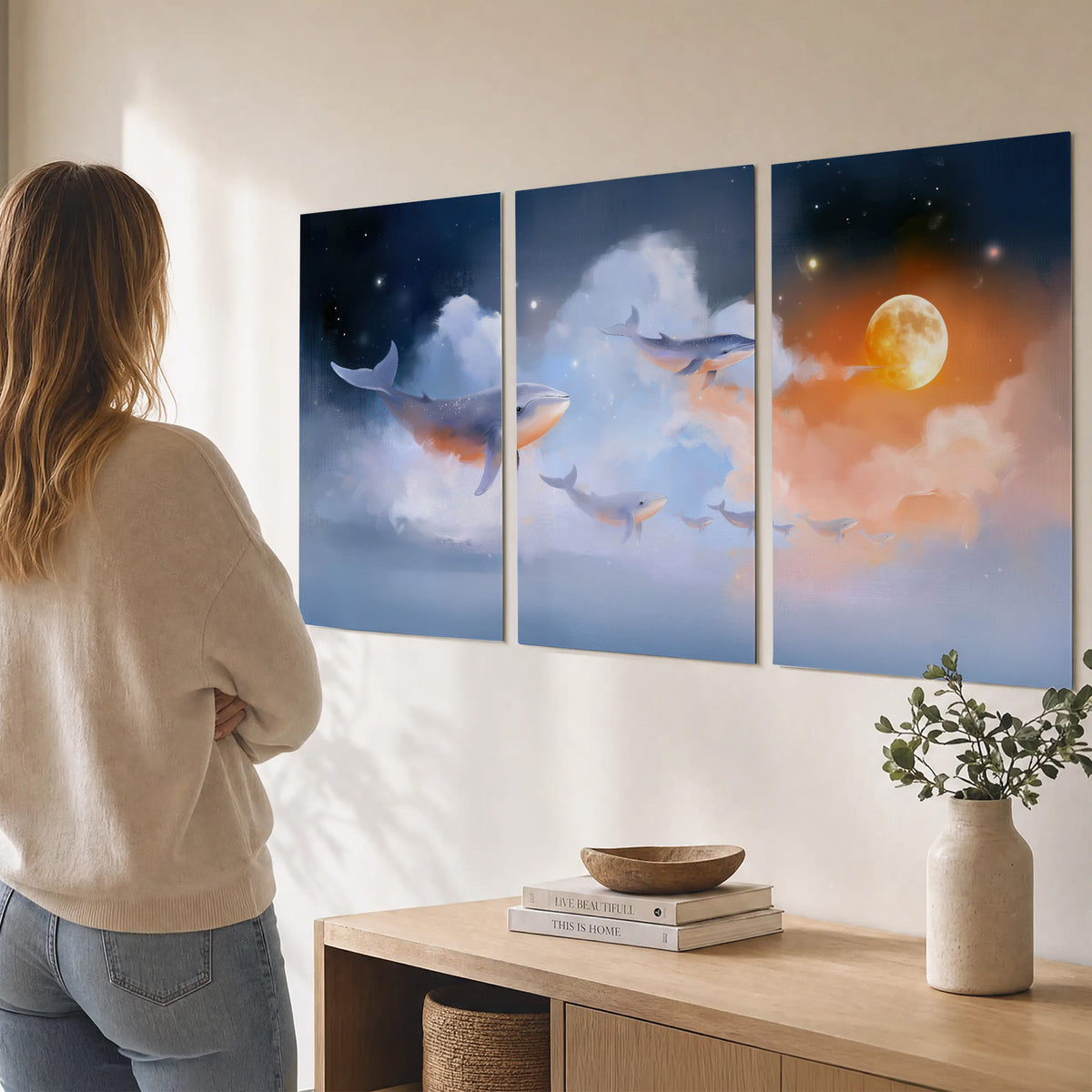 Blue whales gliding through pastel clouds beneath stars and a warm orange moon set of 3 poster prints three panel arrangement on a wall