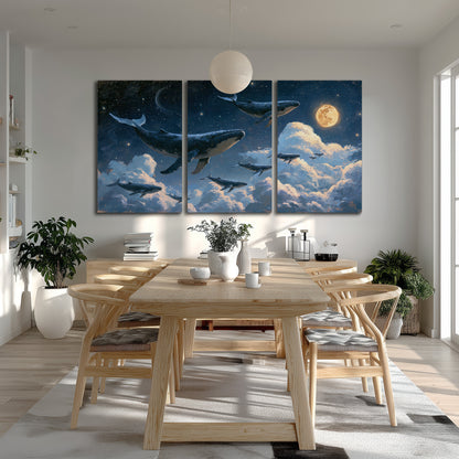 A group of whales floating among clouds beneath a golden moon in a deep blue night sky 3 piece canvas wall art room and product view