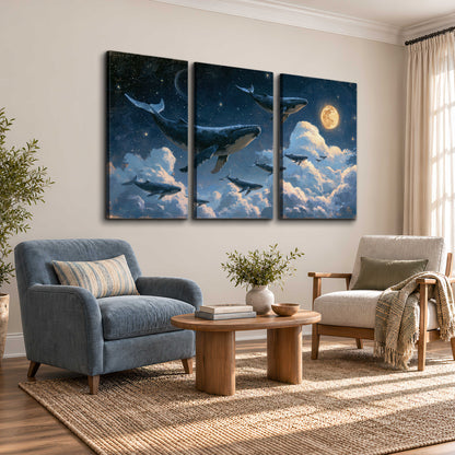 A group of whales floating among clouds beneath a golden moon in a deep blue night sky 3 piece canvas wall art styled in an interior