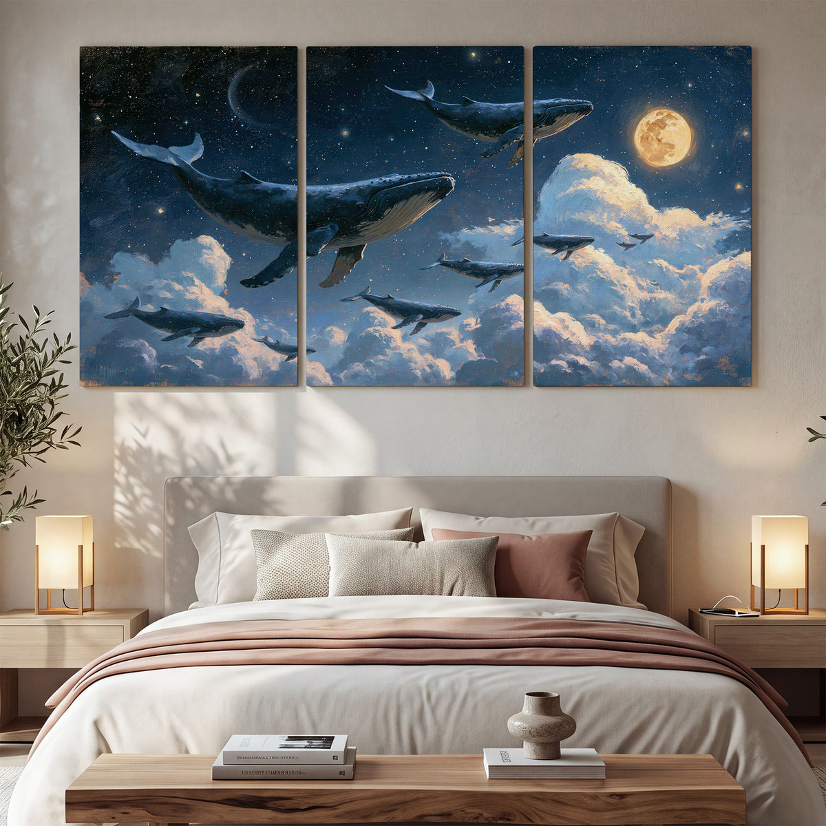 A group of whales floating among clouds beneath a golden moon in a deep blue night sky 3 piece canvas wall art displayed in a bedroom