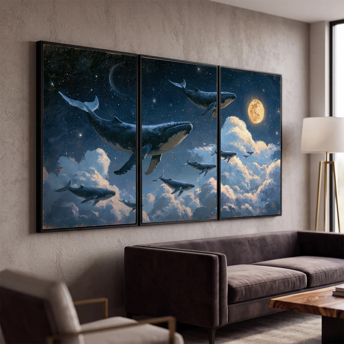 A group of whales floating among clouds beneath a golden moon in a deep blue night sky 3 piece framed canvas wall art displayed in a modern living room