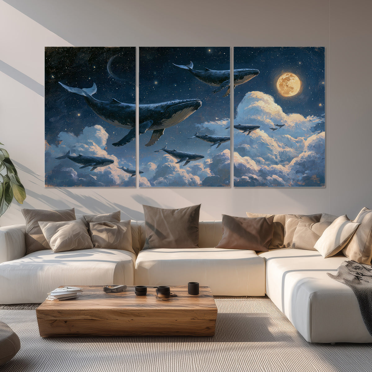 A group of whales floating among clouds beneath a golden moon in a deep blue night sky set of 3 poster prints displayed in a living room