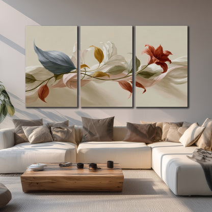 Ivory calla-like flowers and muted red accents curling across a cream background 3 piece canvas wall art displayed in a living room