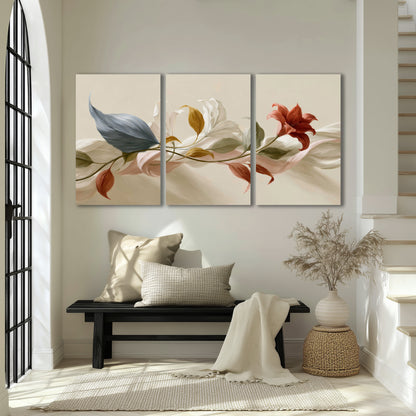 Ivory calla-like flowers and muted red accents curling across a cream background 3 piece canvas wall art displayed in a entryway