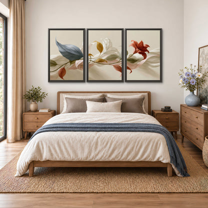 Ivory calla-like flowers and muted red accents curling across a cream background 3 piece framed canvas wall art styled in an interior