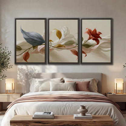 Ivory calla-like flowers and muted red accents curling across a cream background 3 piece framed canvas wall art displayed in a bedroom