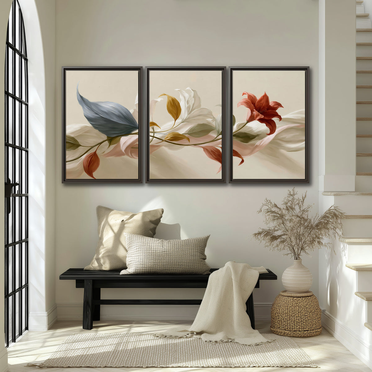 Ivory calla-like flowers and muted red accents curling across a cream background 3 piece framed canvas wall art displayed in a entryway