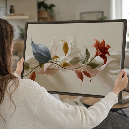 Ivory calla-like flowers and muted red accents curling across a cream background single framed canvas wall art held in hands
