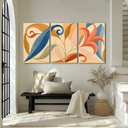 Bold blue, coral and golden leaf-like shapes flowing across a cream ground 3 piece canvas wall art displayed in a entryway