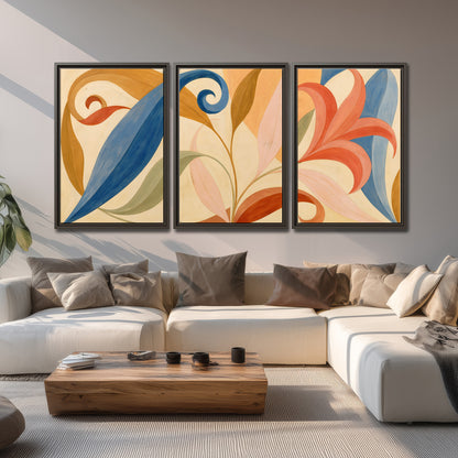 Bold blue, coral and golden leaf-like shapes flowing across a cream ground 3 piece framed canvas wall art displayed in a living room