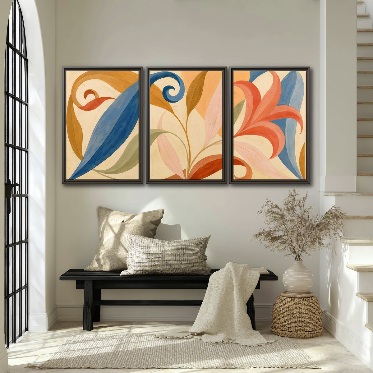 Bold blue, coral and golden leaf-like shapes flowing across a cream ground 3 piece framed canvas wall art displayed in a entryway