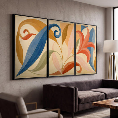 Bold blue, coral and golden leaf-like shapes flowing across a cream ground 3 piece framed canvas wall art displayed in a modern living room