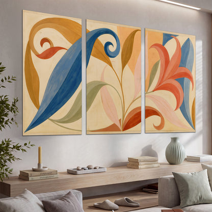 Bold blue, coral and golden leaf-like shapes flowing across a cream ground set of 3 poster prints displayed in a console