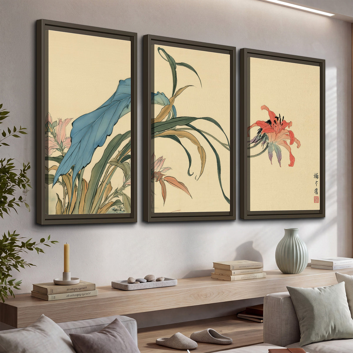 A delicate red flower and long blue-green leaves on a warm cream ground 3 piece framed canvas wall art displayed in a console