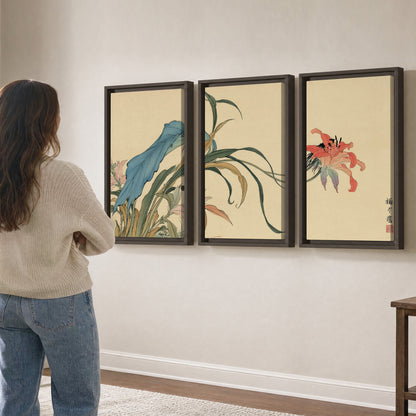 A delicate red flower and long blue-green leaves on a warm cream ground 3 piece framed canvas wall art three panel arrangement on a wall