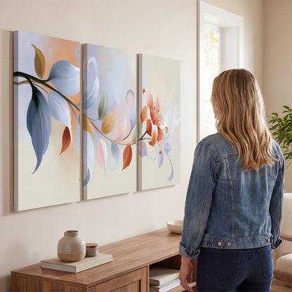 Peach blossoms and blue-green leaves in an airy cream-colored composition 3 piece canvas wall art three panel arrangement on a wall
