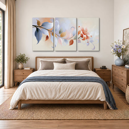 Peach blossoms and blue-green leaves in an airy cream-colored composition 3 piece canvas wall art styled in an interior