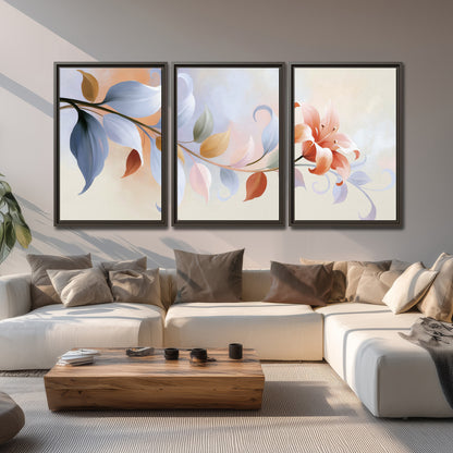 Peach blossoms and blue-green leaves in an airy cream-colored composition 3 piece framed canvas wall art displayed in a living room