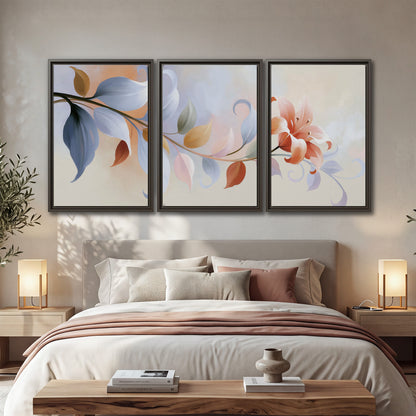 Peach blossoms and blue-green leaves in an airy cream-colored composition 3 piece framed canvas wall art displayed in a bedroom