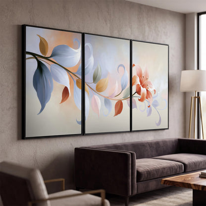 Peach blossoms and blue-green leaves in an airy cream-colored composition 3 piece framed canvas wall art displayed in a modern living room