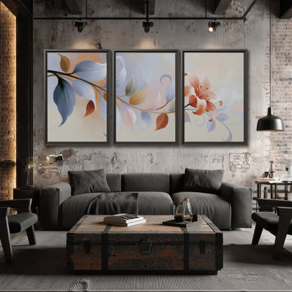 Peach blossoms and blue-green leaves in an airy cream-colored composition 3 piece framed canvas wall art displayed in a industrial room