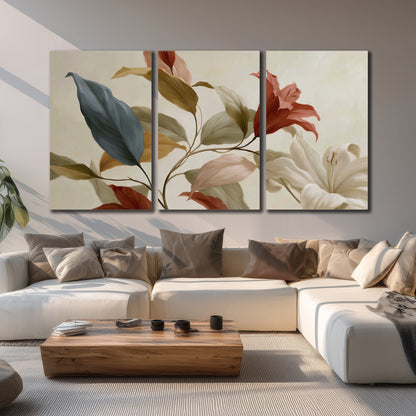 Cream flowers with broad blue and rust leaves sweeping across a neutral background 3 piece canvas wall art displayed in a living room