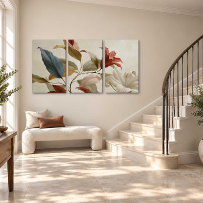 Cream flowers with broad blue and rust leaves sweeping across a neutral background 3 piece canvas wall art styled in an interior