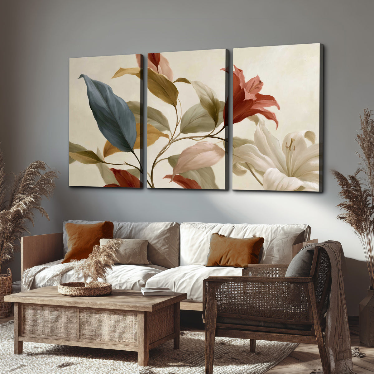 Cream flowers with broad blue and rust leaves sweeping across a neutral background 3 piece canvas wall art displayed in a rustic living room