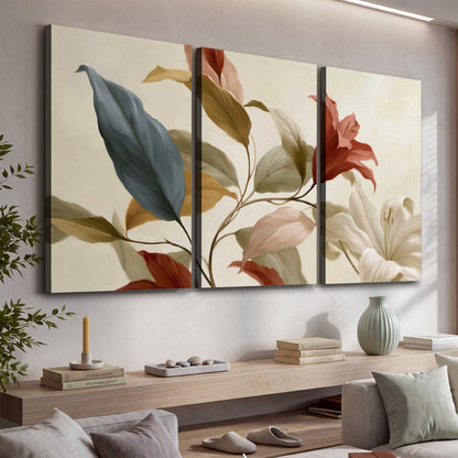 Cream flowers with broad blue and rust leaves sweeping across a neutral background 3 piece canvas wall art displayed in a console