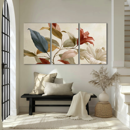 Cream flowers with broad blue and rust leaves sweeping across a neutral background 3 piece canvas wall art displayed in a entryway
