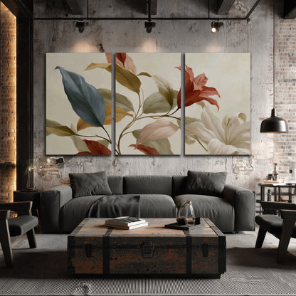 Cream flowers with broad blue and rust leaves sweeping across a neutral background 3 piece canvas wall art displayed in a industrial room