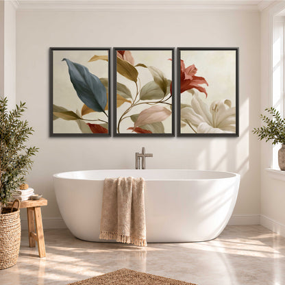 Cream flowers with broad blue and rust leaves sweeping across a neutral background 3 piece framed canvas wall art styled in an interior