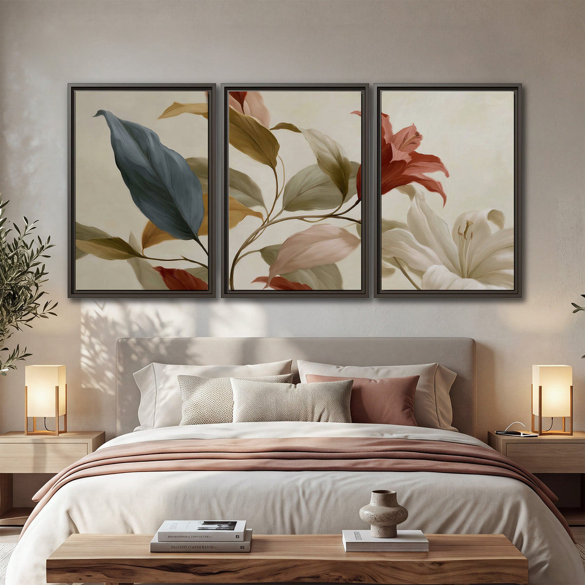 Cream flowers with broad blue and rust leaves sweeping across a neutral background 3 piece framed canvas wall art displayed in a bedroom