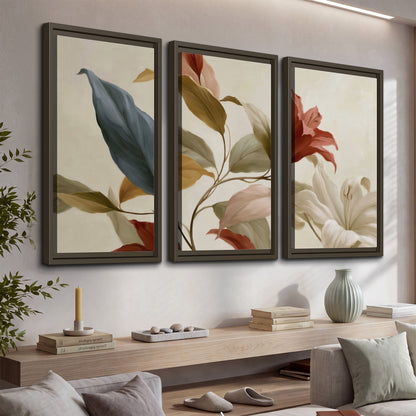 Cream flowers with broad blue and rust leaves sweeping across a neutral background 3 piece framed canvas wall art displayed in a console
