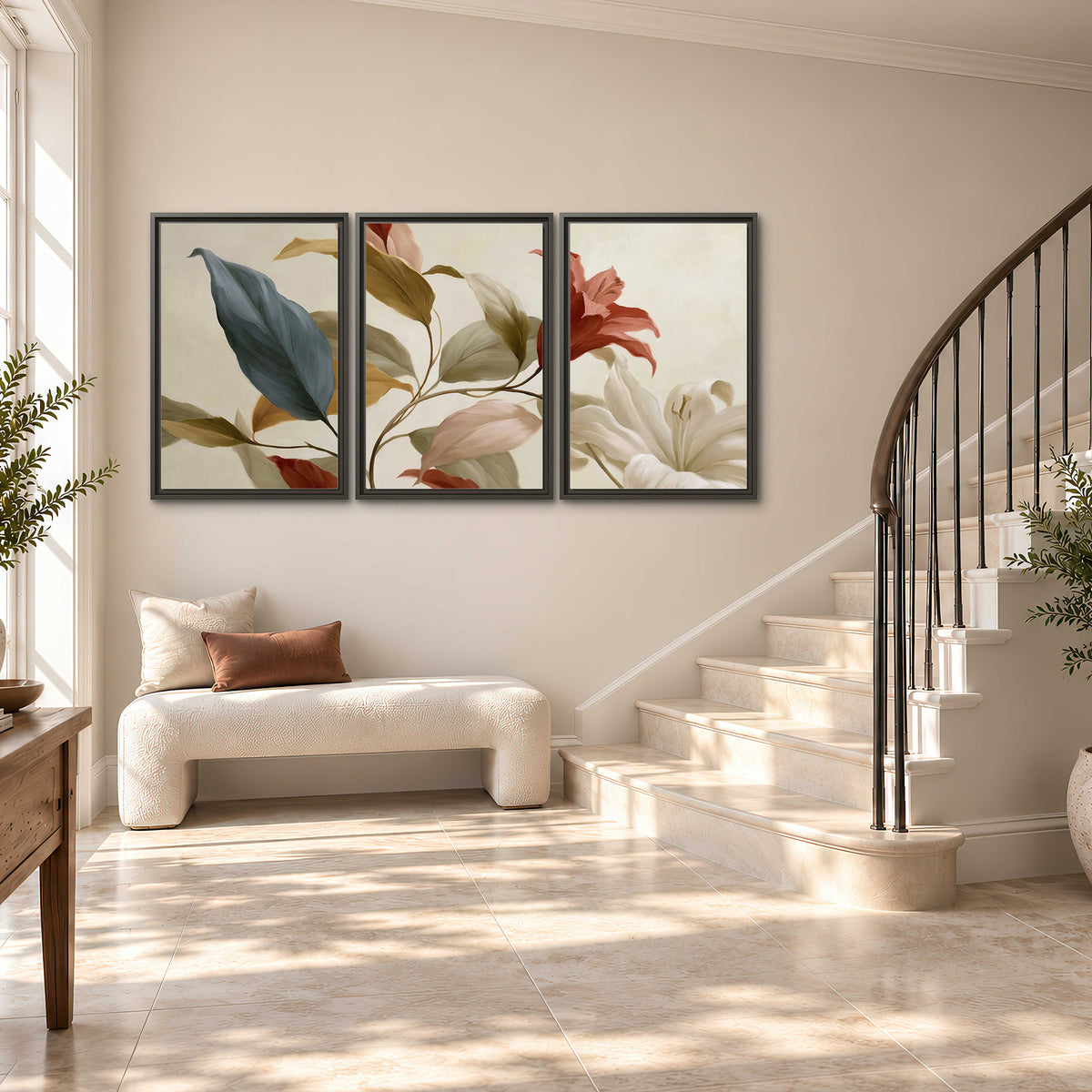 Cream flowers with broad blue and rust leaves sweeping across a neutral background 3 piece framed canvas wall art styled in an interior