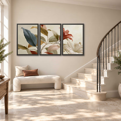 Cream flowers with broad blue and rust leaves sweeping across a neutral background 3 piece framed canvas wall art styled in an interior