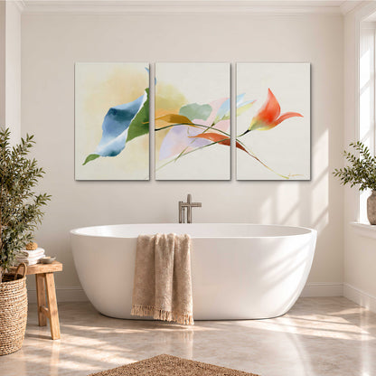Airy green, orange and blue organic shapes floating across a white background 3 piece canvas wall art styled in an interior