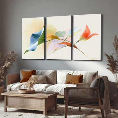 Airy green, orange and blue organic shapes floating across a white background 3 piece canvas wall art displayed in a rustic living room