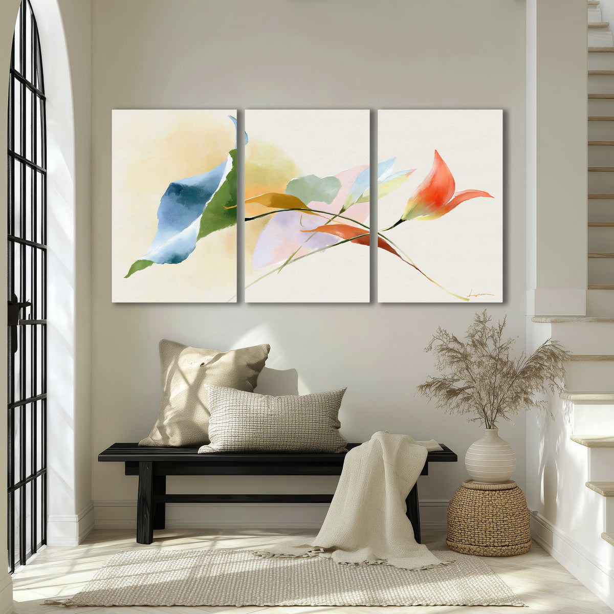 Airy green, orange and blue organic shapes floating across a white background 3 piece canvas wall art displayed in a entryway