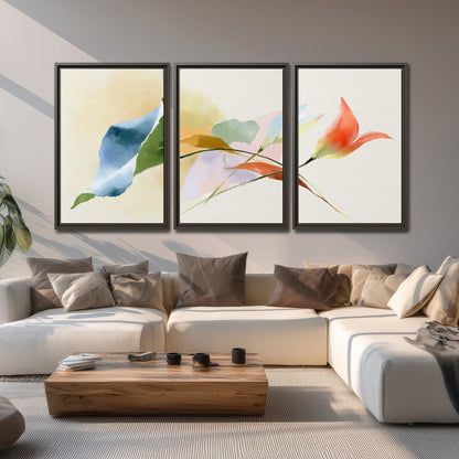 Airy green, orange and blue organic shapes floating across a white background 3 piece framed canvas wall art displayed in a living room