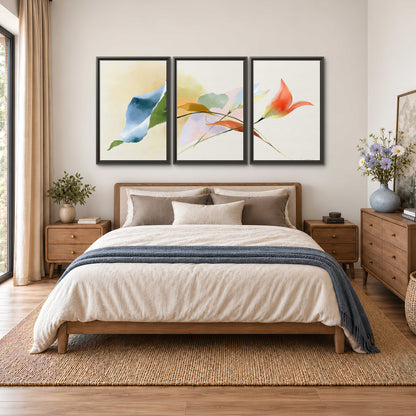 Airy green, orange and blue organic shapes floating across a white background 3 piece framed canvas wall art styled in an interior
