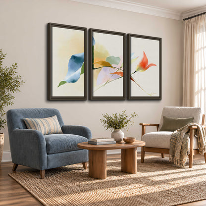 Airy green, orange and blue organic shapes floating across a white background 3 piece framed canvas wall art styled in an interior