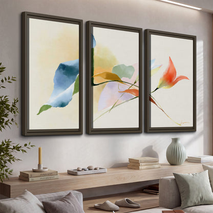 Airy green, orange and blue organic shapes floating across a white background 3 piece framed canvas wall art displayed in a console