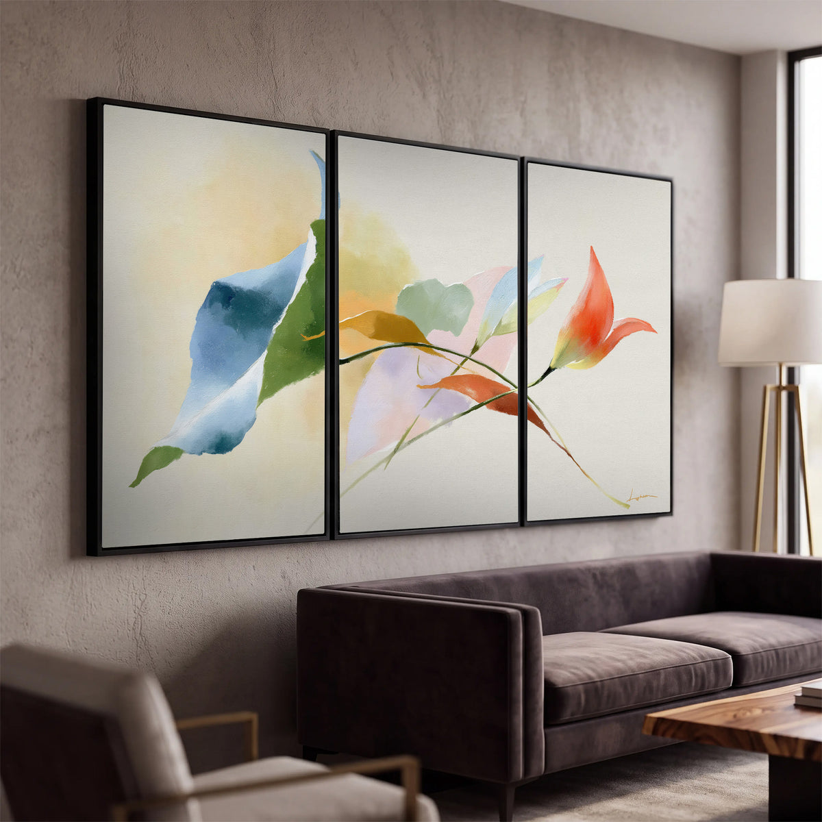 Airy green, orange and blue organic shapes floating across a white background 3 piece framed canvas wall art displayed in a modern living room