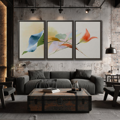 Airy green, orange and blue organic shapes floating across a white background 3 piece framed canvas wall art displayed in a industrial room